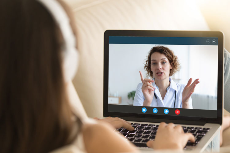 patient and doctor on a video call on a tablet